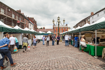 Leek, Staffordshire Moorlands, England, U.K - June 21 2014 : Shoppers at LeekÃ¢ï¿½ï¿½s open air market Leek  is an ancient borough and was granted its royal charter in 1214.のeditorial素材