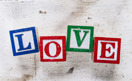 Abstract of old wooden floor boards with colourful toy blocks spelling the word "LOVE" conceptual ideas for valentines day.ptual ideas for valentines day.の写真素材