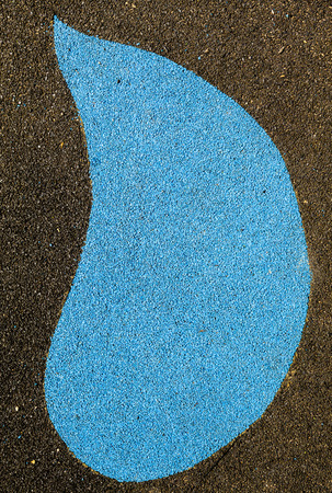 Blue tear drop shape on black background. Wet Pour rubber surface.の写真素材