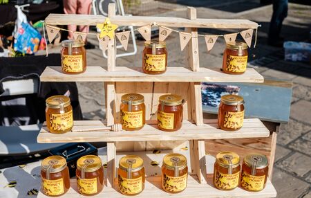 Conwy, Wales UK- September, 13 2019 MEL PUR CYMREIG honey surrounded by hungry bees produce of Wales...