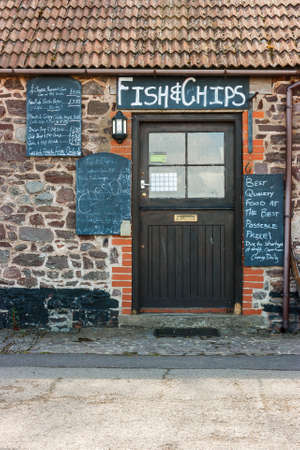 Somerset, Uk, England May 19, 2015: A typical English fish and chip shop closed due to staff shortages. Surrounded by black boards describing food pricesのeditorial素材