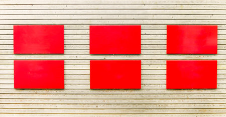 Abstract Wood plank brown texture background with two rows of red rectangular plaquesの写真素材