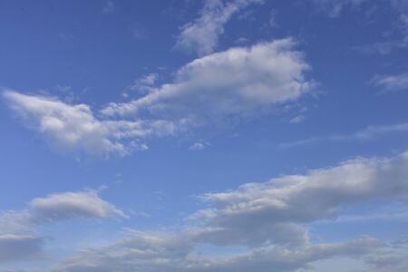 clouds like cotton in a blue skyの写真素材