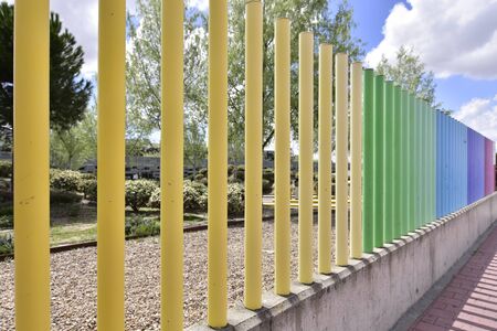 fences with many colors crossing the roadの写真素材
