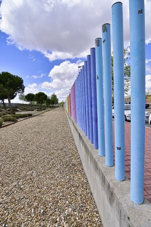 fences with many colors crossing the roadの写真素材