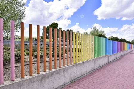 fences with many colors crossing the roadの写真素材