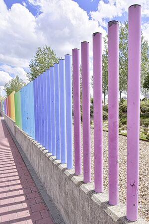 fences with many colors crossing the roadの写真素材