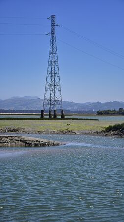 high voltage electrical pylons over the lake in spainの写真素材