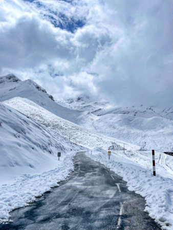 snowy road on a blue day in the north of Spainの写真素材