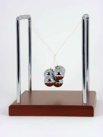Macro photo of twisted Newton''s Cradle on white background