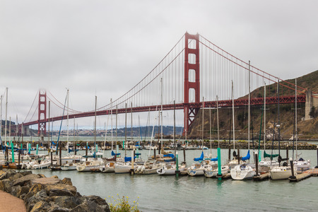 View of the Golden Gate and San Francisco bay area from Sausalito. part of the bridge is covered by the marine layer fog, boats in the Sausalito marinaのeditorial素材