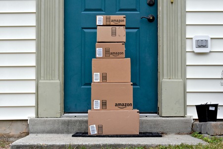 MARYLAND, USA - JANUARY 18, 2016: Image of Amazon packages delivered to a home. Amazon is the largest internet based retailer in the United States.のeditorial素材