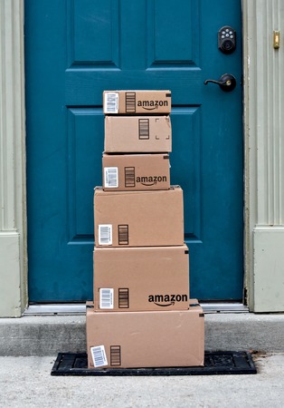 MARYLAND, USA - JANUARY 18, 2016: Image of Amazon packages delivered to a home. Amazon is the largest internet based retailer in the United States.のeditorial素材