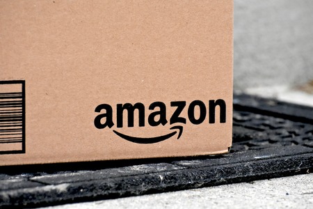 MARYLAND, USA - JANUARY 18, 2016: Image of Amazon packages delivered to a home. Amazon is the largest internet based retailer in the United States.のeditorial素材