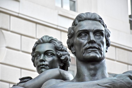 WASHINGTON DC, USA - APRIL 2, 2016: A statue of a man and woman outside the Ronald Reagan Building and International Trade Center in Washington DC. The building is named after a former president.のeditorial素材