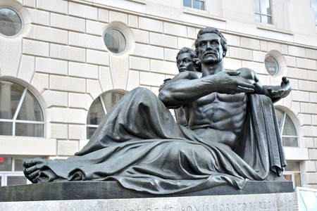 WASHINGTON DC, USA - APRIL 2, 2016: A statue of a man and woman outside the Ronald Reagan Building and International Trade Center in Washington DC. The building is named after a former president.のeditorial素材