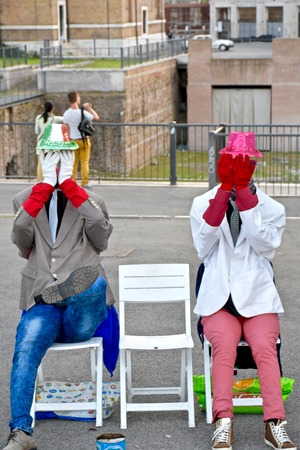 ROME, ITALY - APRIL 16, 2015: Two mimes hiding their faces while performing acts in Rome. Rome is a popular tourist destination in Italy.のeditorial素材