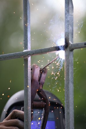 Welder in action on an iron barrier