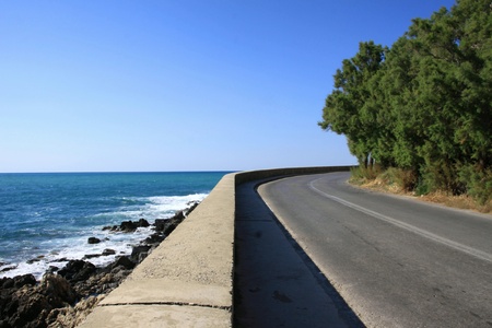 Road between sea and mountain in Creteの写真素材