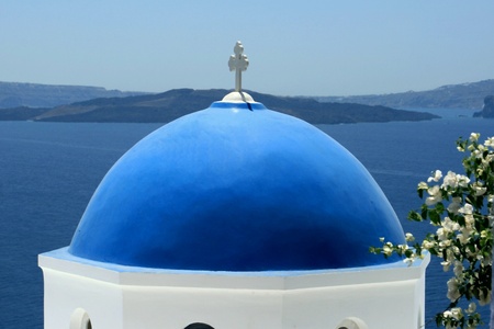 Church in the blue roof to Santorin-Santorini on the background of blue skyの写真素材