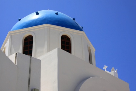 Church in the blue roof to Santorin-Santorini on the background of blue skyの写真素材