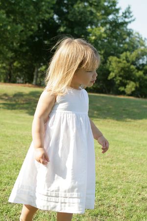 A three year old girl enjoying the outdoors on a spring dayの写真素材