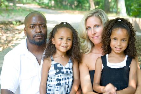 A loving mixed race family enjoying the parkの写真素材