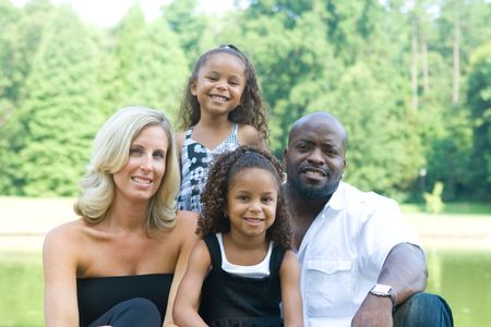 A loving mixed race family enjoying the park A loving mixed race family enjoying the park