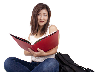 Beautiful Asian girl studying and reading a bookの写真素材