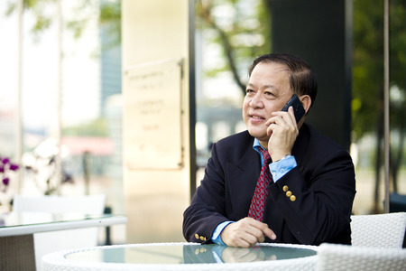 Asian businessman talking on smart phoneの写真素材