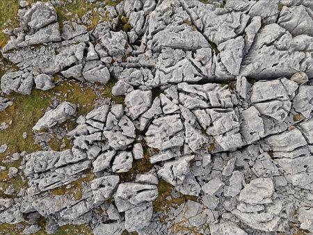 An aerial view captures a rugged terrain of fractured limestone rock formations, displaying nature&apos;s intricate patterns.の写真素材