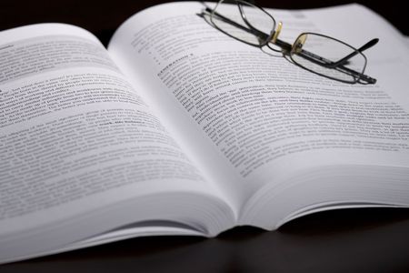 Open book with spectaclesの写真素材