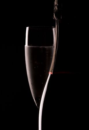 Silhouette of a champagne bottle with glass of bubblyの写真素材