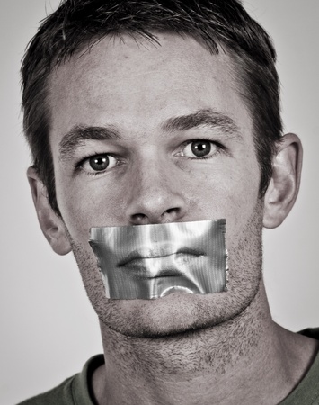 Man with tape over his lipsの写真素材