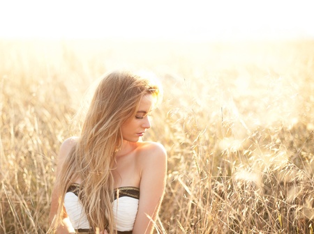 Woman sitting in a field with copy space providedの写真素材