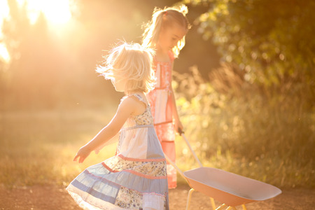 Two little girls playing in the sunの写真素材