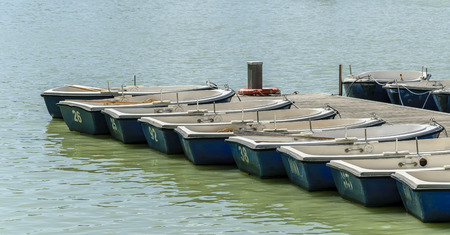 Rowboats in the pier numbered ready to rentの写真素材