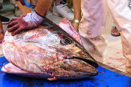 Cutting of red tuna in a fish market in Punta UmbrÃ­a, Huelva, Spainの写真素材