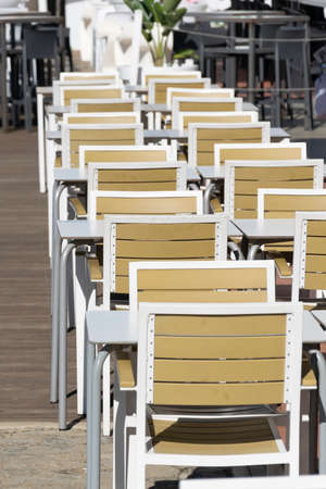 Tables of a terrace arranged in a row with safety distanceの写真素材