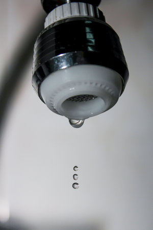 Close-up of a water drop falling from a faucet