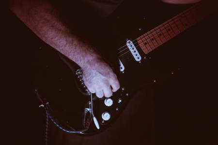 faded colour Close-up  of guitarist playing guitarの写真素材