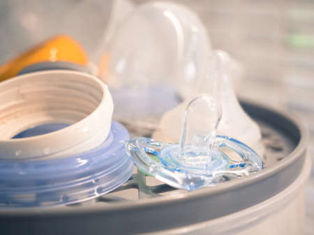 Baby bottle pacifier on sterilize baby bottles machineの写真素材