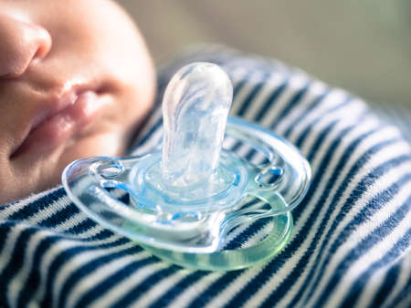 baby with pacifier sleepingの写真素材