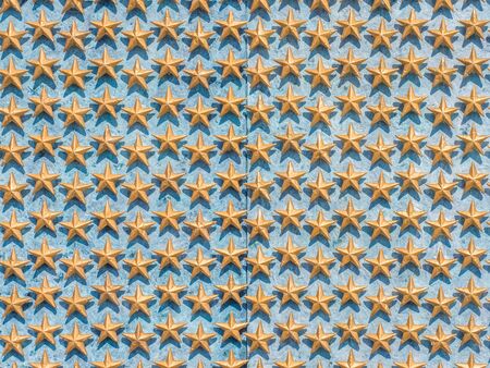 many golden stars on blue backgroundの写真素材