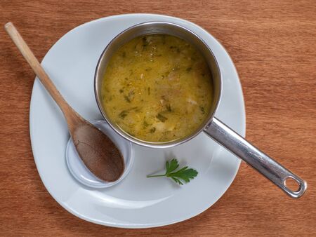 soup in a bowl on a white plateの写真素材