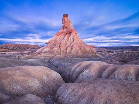 A breathtaking wide-angle shot of Castildetierra, a distinctive geological formation in the Bardenas Reales desert of Navarre, Spain. The unique rock pinnacle is bathed inの写真素材