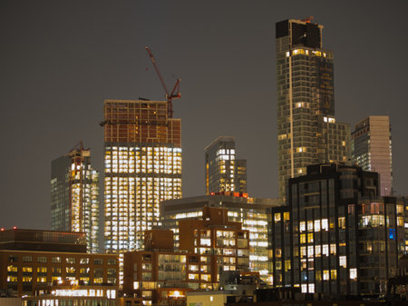 Jersey City Skyline at Night - A view of the Jersey City skyline at night with modern residential...