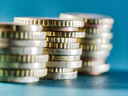 Pile of various coins close up background - A detailed close-up shot of a variety of coins,...