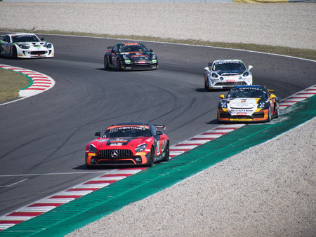 Two Race Cars Cornering on a Racetrack Circuit - An aerial view of two sports cars racing side by...