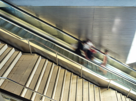 Dynamic motion of people in a subway. - People in motion blur on a Bilbao Metro escalator and...